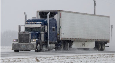 Tractor-trailer on snowy highway