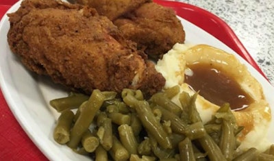 Fried chicken dinner with green beans and mashed potatoes with gravy