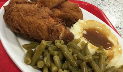 Fried chicken dinner with green beans and mashed potatoes with gravy