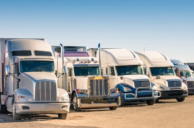 Row of big rigs in parking lot