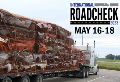 Truckload of crushed cars and Roadcheck logo