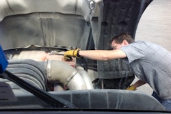 Technician working on truck engine