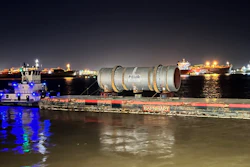 600,000-pound kiln on a barge at night