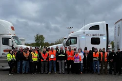 Group of drivers and police officers with two tractor-trailers