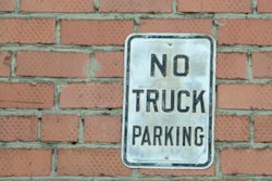 'No Truck Parking' sing on red brick wall