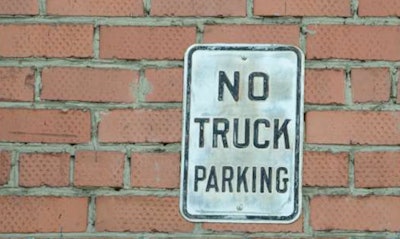 'No Truck Parking' sing on red brick wall