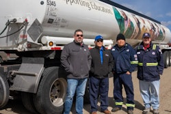 4 men in front of donated tanker rig