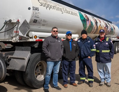 4 men in front of donated tanker rig