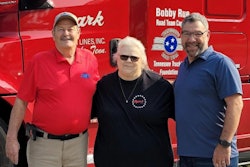 Three people in front of Ozark Motor Lines truck