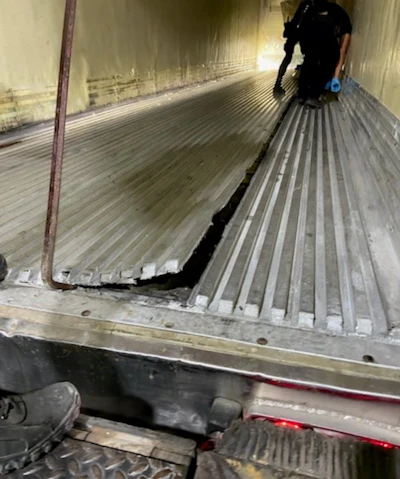 Inspectosr check floor of trail that was found to contain meth