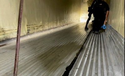 Inspector checks floor of trail that was found to contain meth