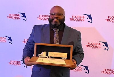 Craig Campbell Sr. holding his award
