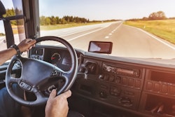 Truck driver at the wheel on the highway
