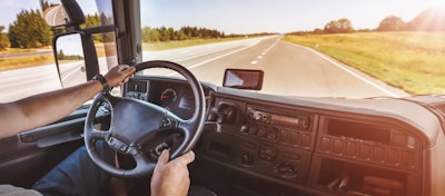 Truck driver at the wheel on the highway