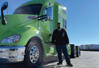 Man in front of his green truck
