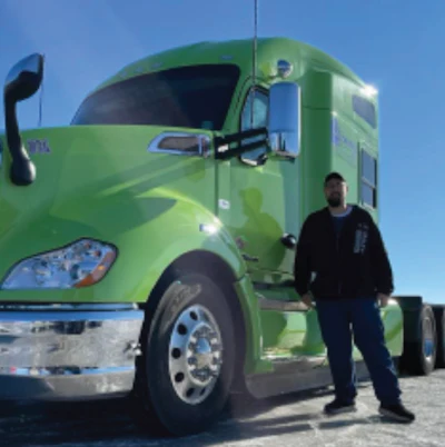 Man in front of his green truck