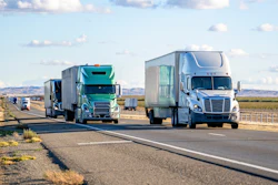 Several tractor-trailers on diviced highway