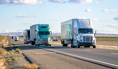 Several tractor-trailers on diviced highway