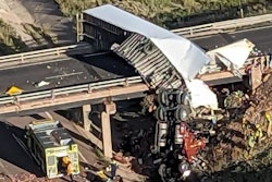 Th cab of the tractor-trailer involved in a crash in Colorado dangled of an I-25 bridge