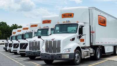 Line of Yellow tractor-trailers