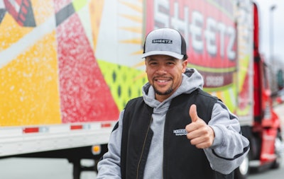 Truck driver in front of Sheetz tractor-trailer