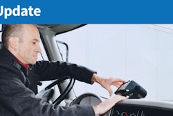 Truck driver adjusting ELD