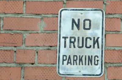 'No Truck Parking' sign on brick wall