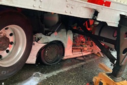 Car trapped under the trailer of a tractor-trailer