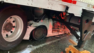 Car trapped under the trailer of a tractor-trailer