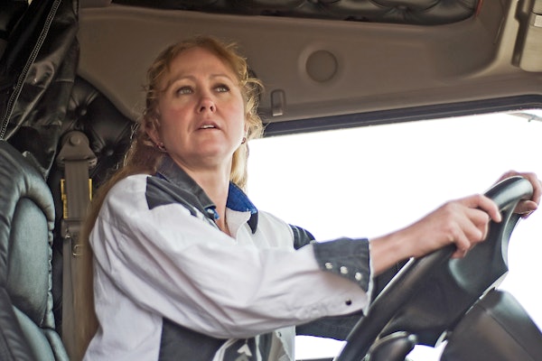 Woman at the wheel of a truck
