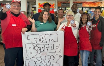 TA employees hold 'Team Battle Creek' sign