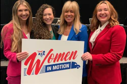 Womne holdinf 'Women In Motion' sign