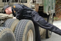 Police officer inspecting a truck