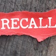 'Recall' in white on red torn paper