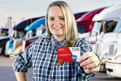 Woman truck driver holing TVC membership card
