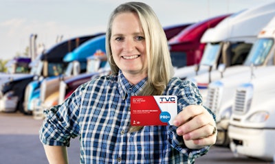 Woman truck driver holing TVC membership card