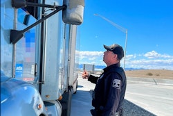 Arizona Department of Public Safety trooper talking to truck driver