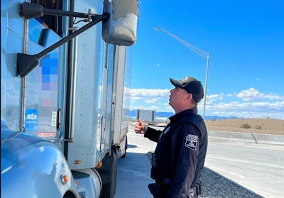 Arizona Department of Public Safety trooper talking to truck driver