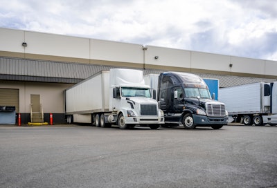 Tractor-trailers being loaded at terminal