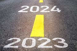 2023 and 2024 painted on highway with yellow stripes