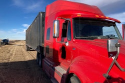 Red tractor-trailer stopped on highway