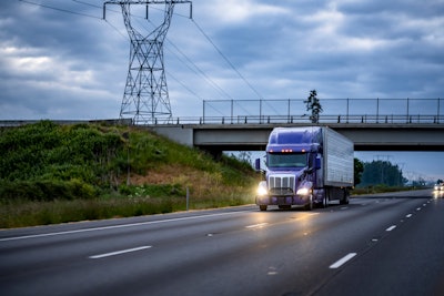 Big rig on highway with overcast sky