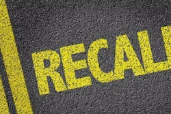 'Recall' painted on pavement in yellow