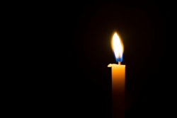 Memorial candle on black background