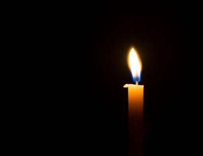 Memorial candle on black background