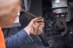 Technician working on truck engine