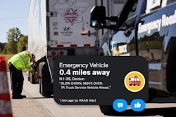 Roadside emergency technician working on tractor-trailer