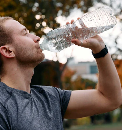 Man. drinking from a water bottle