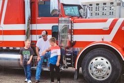 Missing trucker David Schultz and his two sons in front of his truck