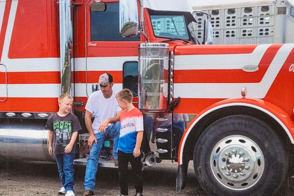 Missing trucker David Schultz and his two sons in front of his truck